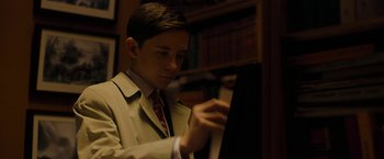 Movie still from “Pawn Sacrifice” (2014), directed by Edward Zwick – A young man in a suit and tie playing a piano; Close Up shot, Low angle