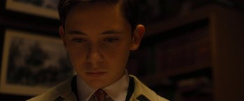 Movie still from “Pawn Sacrifice” (2014), directed by Edward Zwick – A young man wearing a suit and a tie; Close Up shot, High angle