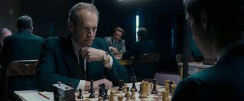 Movie still from “Pawn Sacrifice” (2014), directed by Edward Zwick – A man sitting at a chess table with a chess set; Close Up shot, Over the shoulder angle