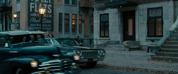 Movie still from “Pawn Sacrifice” (2014), directed by Edward Zwick – An old car parked on the side of the street; Wide shot, Over the shoulder angle