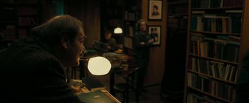 Movie still from “Pawn Sacrifice” (2014), directed by Edward Zwick – A man sitting at a table in a room; Medium shot, Over the shoulder angle