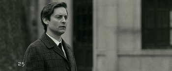 Movie still from “Pawn Sacrifice” (2014), directed by Edward Zwick – A black and white photo of a man in a suit and tie; Close Up shot, Low angle
