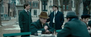 Movie still from “Pawn Sacrifice” (2014), directed by Edward Zwick – A group of men standing next to each other on a table; Medium shot, Over the shoulder angle
