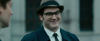 Movie still from “Pawn Sacrifice” (2014), directed by Edward Zwick – A person wearing glasses and a hat; Close Up shot, Over the shoulder angle