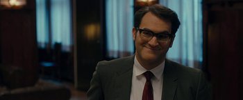 Movie still from “Pawn Sacrifice” (2014), directed by Edward Zwick – A man in a suit and tie smiling for the camera; Close Up shot, Over the shoulder angle