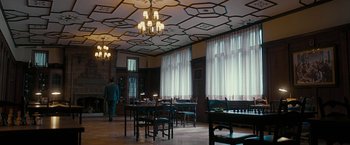Movie still from “Pawn Sacrifice” (2014), directed by Edward Zwick – A room filled with tables and chairs in a room; Extreme Wide shot, Low angle