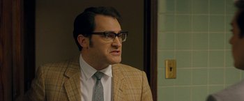 Movie still from “Pawn Sacrifice” (2014), directed by Edward Zwick – A man in a suit and tie wearing glasses and a tie; Close Up shot, Over the shoulder angle