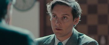 Movie still from “Pawn Sacrifice” (2014), directed by Edward Zwick – A person wearing a suit and tie; Close Up shot, Over the shoulder angle