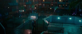 Movie still from “Pawn Sacrifice” (2014), directed by Edward Zwick – A man standing next to a pool at night; Extreme Wide shot, High angle