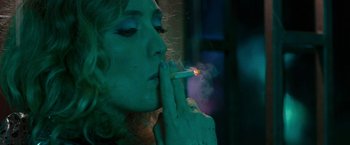 Movie still from “Pawn Sacrifice” (2014), directed by Edward Zwick – A woman is smoking a cigarette in a dark room; Close Up shot, Overhead angle