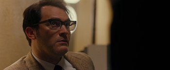 Movie still from “Pawn Sacrifice” (2014), directed by Edward Zwick – A person wearing a suit and glasses; Close Up shot, Over the shoulder angle