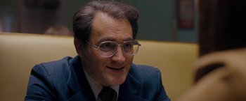 Movie still from “Pawn Sacrifice” (2014), directed by Edward Zwick – A person wearing a suit and glasses; Close Up shot, Over the shoulder angle