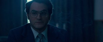 Movie still from “Pawn Sacrifice” (2014), directed by Edward Zwick – A man in a suit and tie with glasses looking straight ahead; Close Up shot, Over the shoulder angle