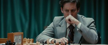Movie still from “Pawn Sacrifice” (2014), directed by Edward Zwick – A man sitting at a chess table with his hand to his face; Close Up shot, Over the shoulder angle