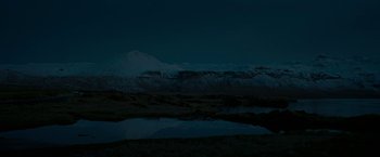 Movie still from “Pawn Sacrifice” (2014), directed by Edward Zwick – A mountain range with a body of water in the foreground; Extreme Wide shot, High angle