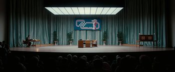 Movie still from “Pawn Sacrifice” (2014), directed by Edward Zwick – A large audience is sitting in front of a stage; Extreme Wide shot, High angle