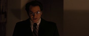 Movie still from “Pawn Sacrifice” (2014), directed by Edward Zwick – A man in a suit and tie with glasses; Close Up shot, Low angle