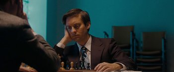 Movie still from “Pawn Sacrifice” (2014), directed by Edward Zwick – A man sitting at a table playing chess; Close Up shot, High angle