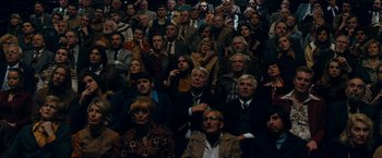 Movie still from “Pawn Sacrifice” (2014), directed by Edward Zwick – A group of people sitting in a room watching a show; Wide shot, High angle