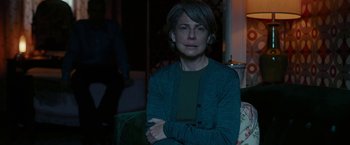 Movie still from “Pawn Sacrifice” (2014), directed by Edward Zwick – A woman sitting on a couch in a room; Medium shot, Over the shoulder angle