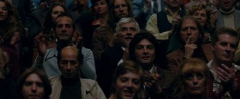 Movie still from “Pawn Sacrifice” (2014), directed by Edward Zwick – A group of people sitting in a room watching a show; Close Up shot, Over the shoulder angle
