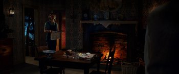 Movie still from “Pearl” (2022), directed by Ti West – A table and chairs in front of a fire place; Wide shot, High angle