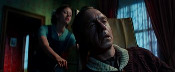 Movie still from “Pearl” (2022), directed by Ti West – An older man and a young girl in a room; Medium shot, Low angle