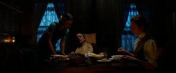 Movie still from “Pearl” (2022), directed by Ti West – A group of people sitting at a dinner table; Medium shot, Low angle