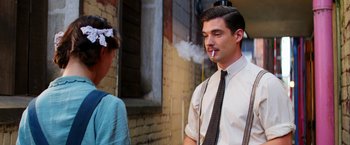 Movie still from “Pearl” (2022), directed by Ti West – A man smoking a cigarette while talking to a woman; Medium shot, Over the shoulder angle