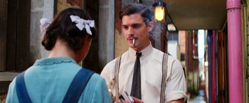 Movie still from “Pearl” (2022), directed by Ti West – A man smoking a cigarette while talking to a woman; Medium shot, Over the shoulder angle