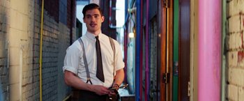 Movie still from “Pearl” (2022), directed by Ti West – A man in a white dress shirt and brown tie; Medium shot, Low angle