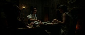 Movie still from “Pearl” (2022), directed by Ti West – A group of people sitting around a table; Medium shot, High angle