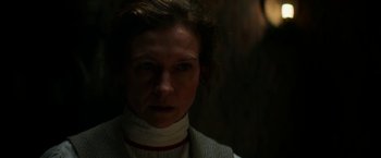 Movie still from “Pearl” (2022), directed by Ti West – A woman wearing a neck brace looking at the camera; Close Up shot, Low angle