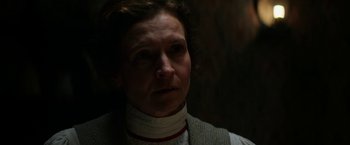 Movie still from “Pearl” (2022), directed by Ti West – A woman wearing a neck brace looking to her left; Close Up shot, Over the shoulder angle