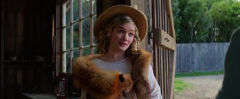 Movie still from “Pearl” (2022), directed by Ti West – A young woman wearing a hat and a fur coat; Close Up shot, Over the shoulder angle