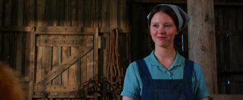 Movie still from “Pearl” (2022), directed by Ti West – A woman standing in front of a wooden wall; Close Up shot, Low angle