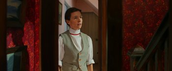 Movie still from “Pearl” (2022), directed by Ti West – A woman standing in front of an open door; Medium shot, Low angle