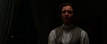 Movie still from “Pearl” (2022), directed by Ti West – A woman wearing a white shirt and a vest; Close Up shot, Low angle