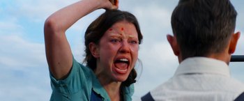 Movie still from “Pearl” (2022), directed by Ti West – A woman with a red spot on her forehead; Close Up shot, Low angle