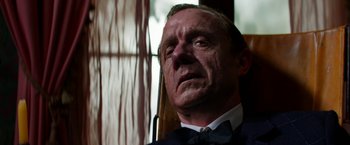 Movie still from “Pearl” (2022), directed by Ti West – An older man wearing a bow tie and a suit; Close Up shot, Low angle