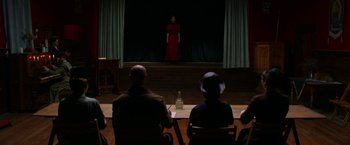 Movie still from “Pearl” (2022), directed by Ti West – A woman in a red dress is on a stage; Wide shot, Over the shoulder angle