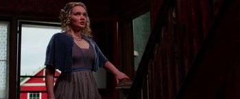 Movie still from “Pearl” (2022), directed by Ti West – A woman standing on the stairs of a house; Medium shot, Low angle