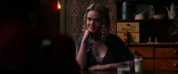 Movie still from “Pearl” (2022), directed by Ti West – A woman sitting at a table in front of a mirror; Close Up shot, Over the shoulder angle