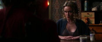 Movie still from “Pearl” (2022), directed by Ti West – A woman sitting at a table in front of a mirror; Medium shot, Over the shoulder angle