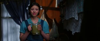 Movie still from “Pearl” (2022), directed by Ti West – A woman holding a cup in her hands; Medium shot, Over the shoulder angle