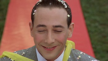 Movie still from “Pee-wee's Big Adventure” (1985), directed by Tim Burton – A person with confetti on their head; Close Up shot, Low angle