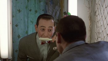 Movie still from “Pee-wee's Big Adventure” (1985), directed by Tim Burton – A man is brushing his teeth in the mirror; Close Up shot, Over the shoulder angle