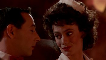 Movie still from “Pee-wee's Big Adventure” (1985), directed by Tim Burton – A man and a woman are looking at one another; Close Up shot, Over the shoulder angle