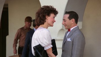 Movie still from “Pee-wee's Big Adventure” (1985), directed by Tim Burton – A man and a woman standing next to each other; Medium shot, Over the shoulder angle