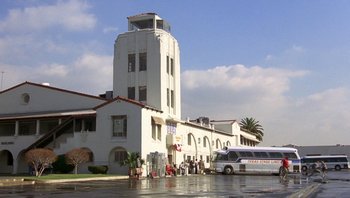 Movie still from “Pee-wee's Big Adventure” (1985), directed by Tim Burton – A bus parked in front of a large building; Extreme Wide shot, Low angle